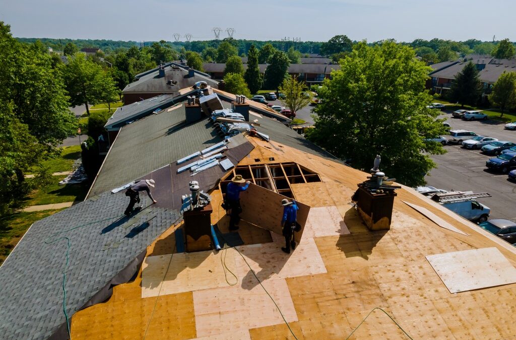 Roof shingles need with new shingles of an apartment building replacing gray asphalt tile